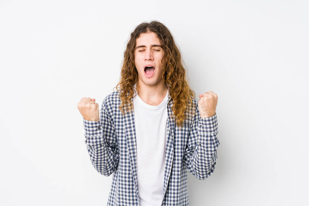 Young long hair man posing isolated cheering carefree and excited. Victory concept. - Photo, Image