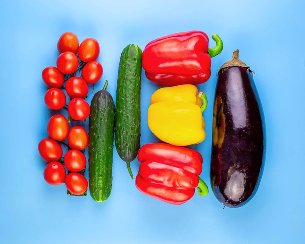 Food background of different vegetables on blue background. Top view. - Foto, Bild