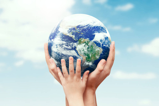 Earth globe in family hands. World environment day - Foto, imagen