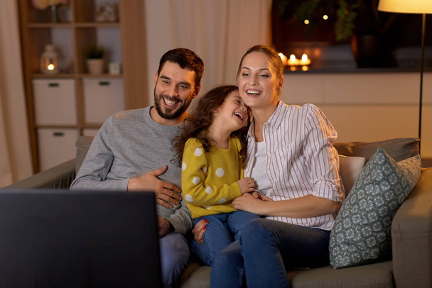 happy family watching tv at home at night - Fotó, kép