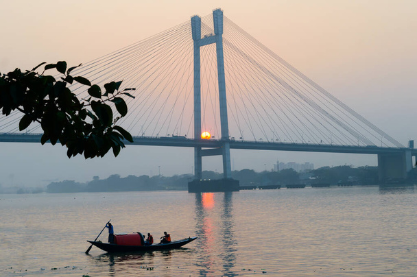 Panoramic Vidyasagar Setu or Hooghly Bridge during sunset. Famous longest cable stayed toll flyover over Ganges River connection cities Kolkata and Howrah. Calcutta West Bengal India South Asia Pac. - Photo, Image