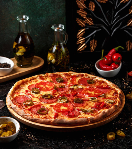 pepperoni pizza with olives on wooden board - Foto, Imagem