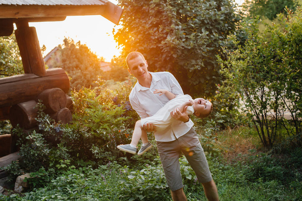 Father and son walking in the Park at sunset. Happiness. Love - Valokuva, kuva