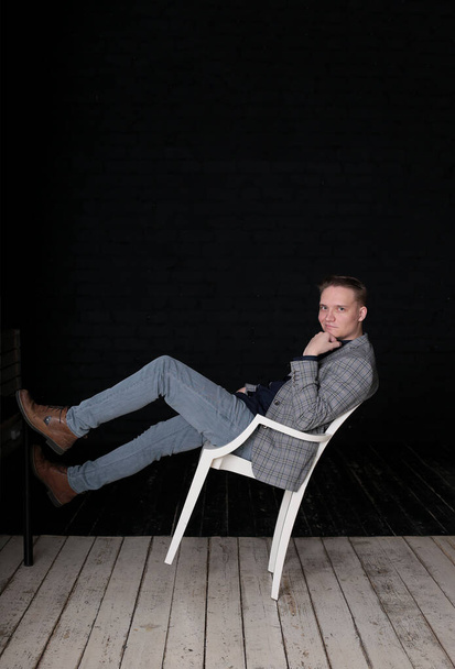 portrait emotional stylish young man in a jacket and shirt on a dark background - Φωτογραφία, εικόνα