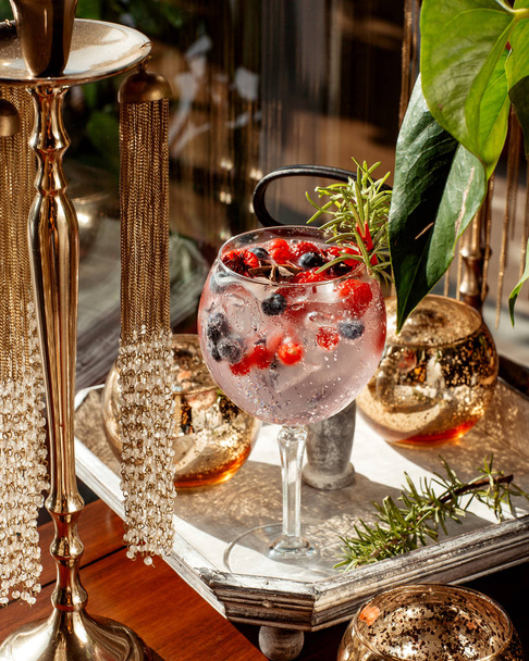 a glass of berry cocktail with blueberry cranberry and raspberry - Zdjęcie, obraz