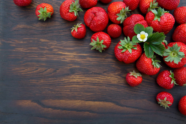 Macro shot on strawberries over wooden background. - Foto, Bild