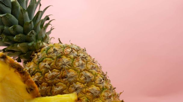 Close-up of isolated pineapple on a pink background on the left with space for text on the right. Healthy and ecological food concept. - Fotoğraf, Görsel