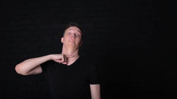 portrait emotional cool stylish young guy in a black t-shirt and shirt on a dark background - 写真・画像