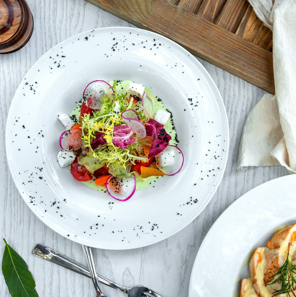 greek salad decorated with radish slices - 写真・画像