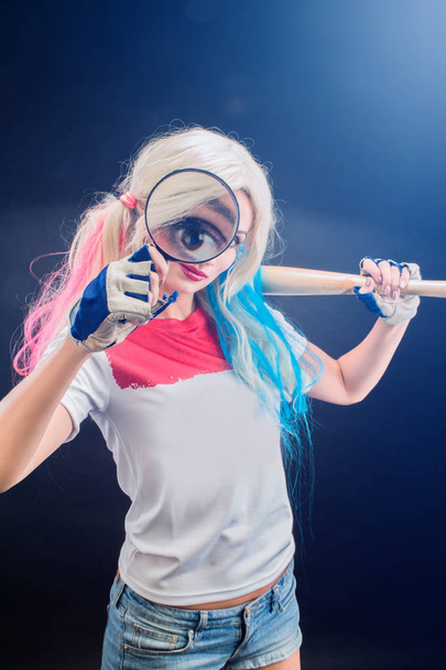 Cosplayer woman dressed as Harley, cosplay character from the movie. The girl  blonde with a baseball bat. - Photo, Image