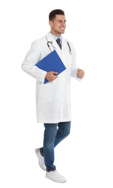 Doctor with clipboard walking on white background - Фото, изображение