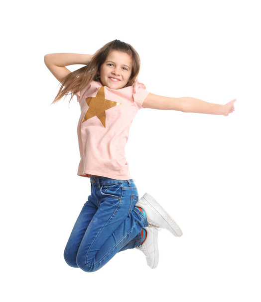 Full length portrait of preteen girl jumping on white background - Фото, изображение