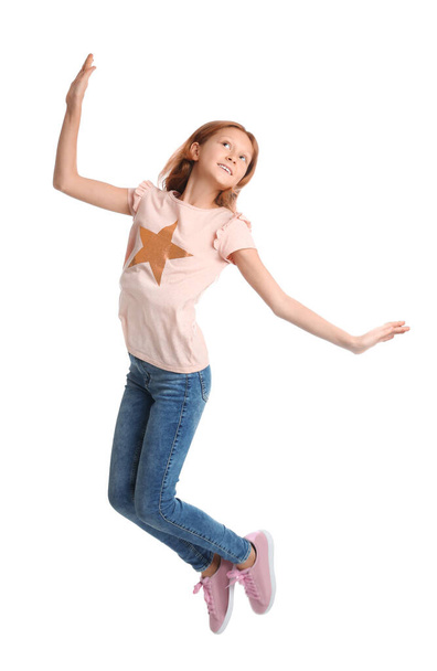 Full length portrait of preteen girl jumping on white background - Valokuva, kuva