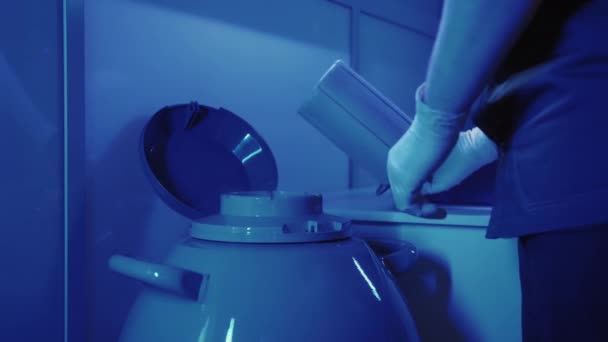 専門の胚学者は、クリオバンクから胚とカプセルを取ります - 映像、動画