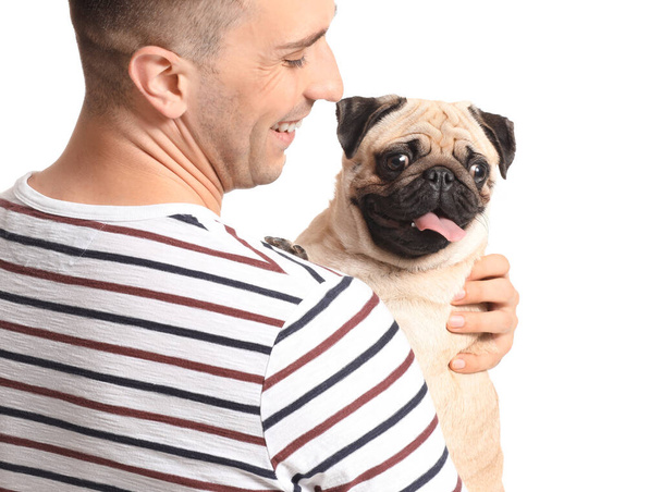 Handsome man with cute pug dog on white background - Фото, изображение