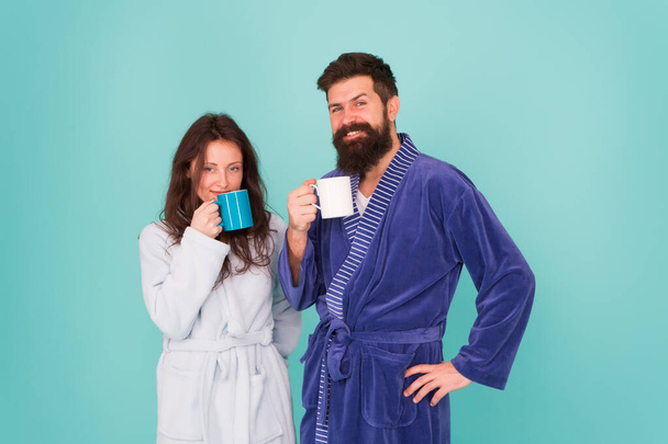 Coffee is our tradition. Man and woman happy together. Family traditions. Daily life and routine. Couple in cozy bathrobes enjoy lazy weekend. Drinking coffee. Brewing coffee at home. Hot drink - Φωτογραφία, εικόνα