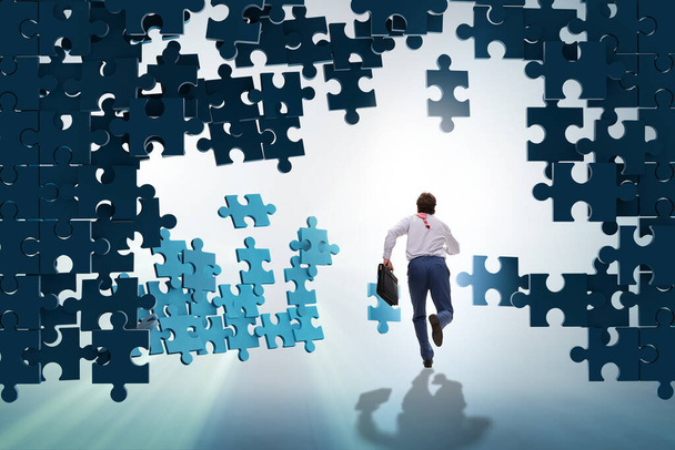 Businessman breaking the wall of jigsaw puzzle - Photo, Image