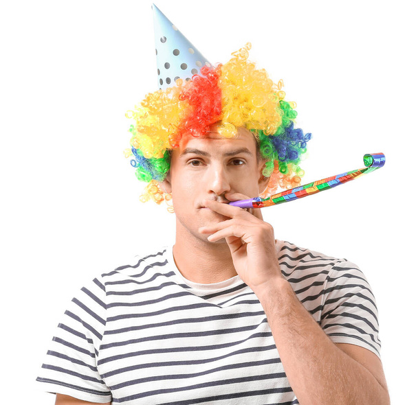 Man in funny disguise and with party whistle on white background. April fools' day celebration - Photo, Image