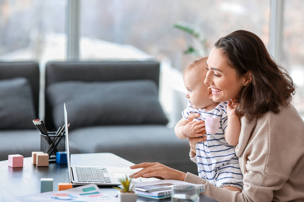 Working mother with her baby in office - Photo, Image