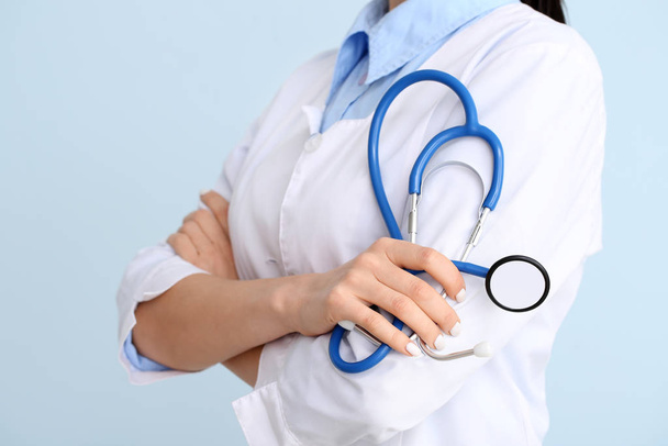Female cardiologist on color background, closeup - Фото, изображение