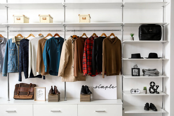Modern wardrobe with stylish winter clothes and accessories - Fotoğraf, Görsel