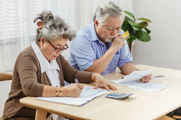 Stressed senior elderly couple conclict of credit card bills or  - Photo, Image