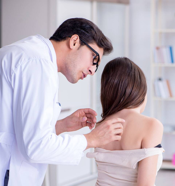 Doctor examining the skin of female patient - Photo, Image