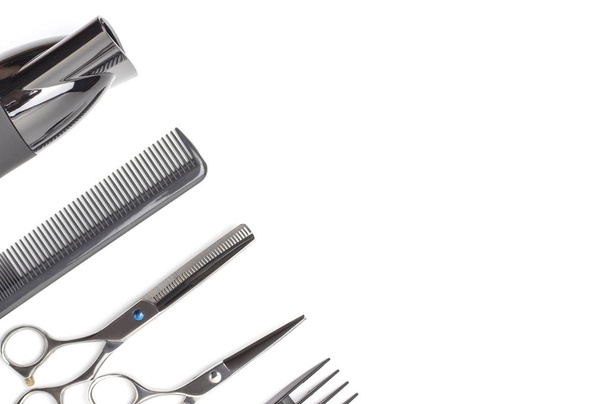 Hairdressing tools and hairdryer on white background, top view, copy space. - 写真・画像
