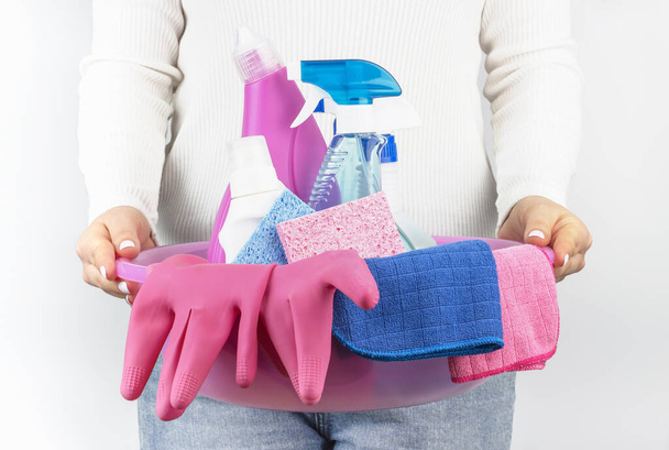 Woman holding basin with detergents and gloves side view - Photo, Image