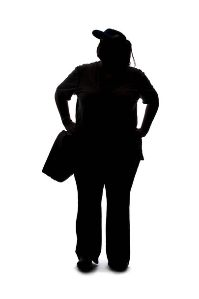 Silhouette of a curvy or plus size woman on a white background.  She is unrecognizable and standing or waiting - Foto, imagen