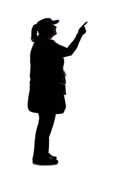 Silhouette of a curvy or plus size woman on a white background.  She is unrecognizable and is wearing casual apparel while pointing at something - 写真・画像