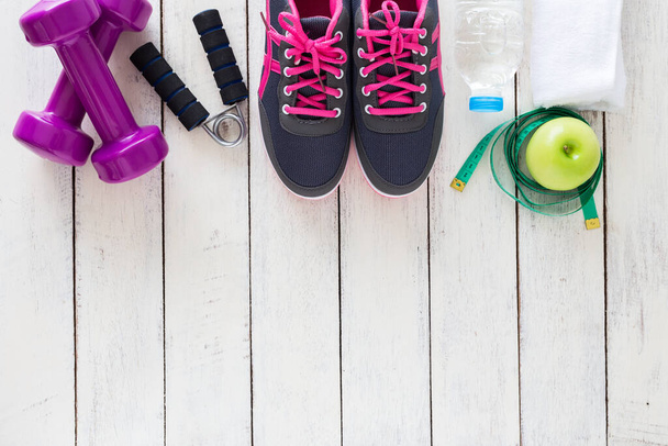 Fitness healthy concept,sneakers,apple,water and measuring tape on wooden background ,top view - Foto, imagen