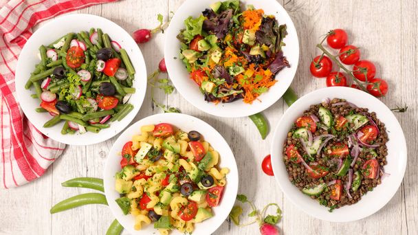 assorted of vegetarian salad bowl with lentils, avocado, tomato, bean or pasta - Fotografie, Obrázek