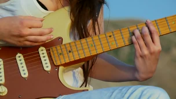genç kadın gitar çalıyor. yakın çekim. Gitar akorları. - Video, Çekim