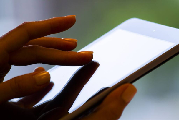 O dedo feminino clica em um tablet digital, conceito de negócios e tecnologia. Fechar
 - Foto, Imagem