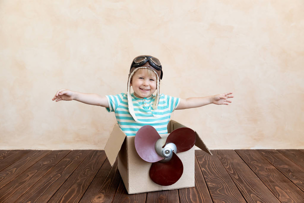 Happy child playing with toy airplane - 写真・画像