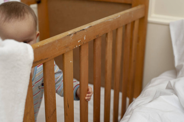 Infant baby in an old wood cot. - Photo, Image