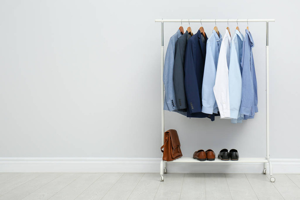 Rack with stylish men's clothes in room. Space for text - Fotografie, Obrázek