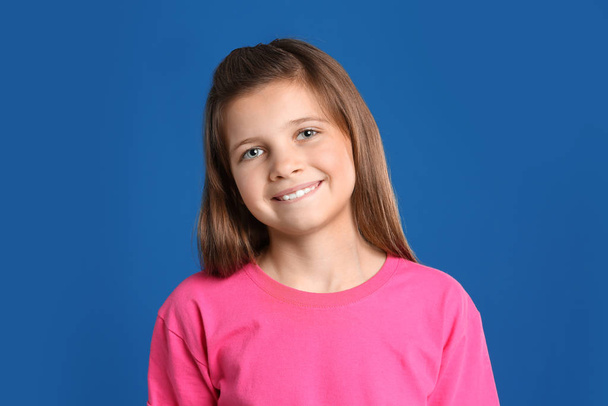 Portrait of preteen girl on blue background - Fotografie, Obrázek