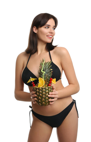 Beautiful woman in stylish bikini holding tropical cocktail on white background - 写真・画像