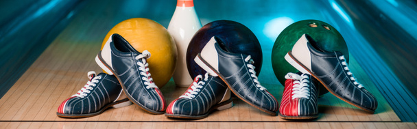 panoramic shot of bowling shoes, balls and skittles in bowling club - Photo, Image