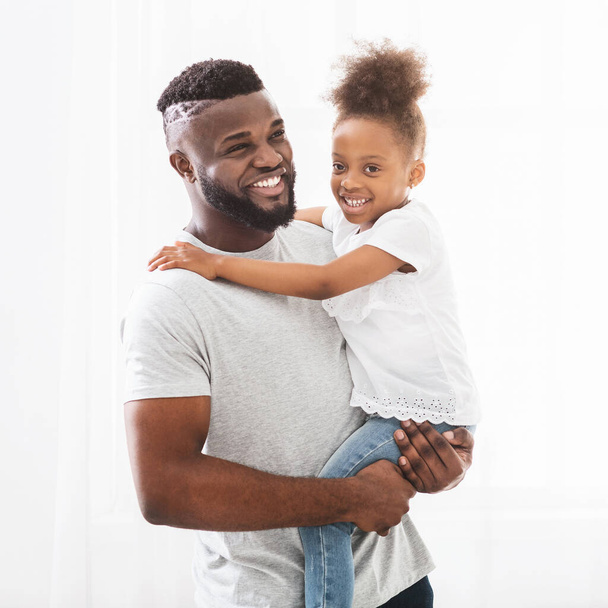 Portrait of black dad and little daughter over white background - Photo, Image