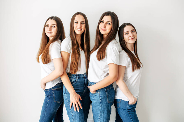 Group of young girls in similar clothes in studio - Φωτογραφία, εικόνα