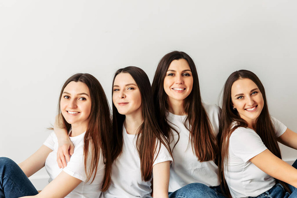 A group of young girls in identical white t-shirts - Zdjęcie, obraz
