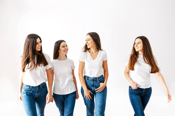 Young positive girls in white blank t-shirts - Fotó, kép