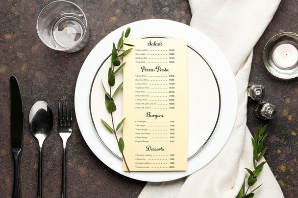 Beautiful table setting with menu on grey background - Foto, imagen