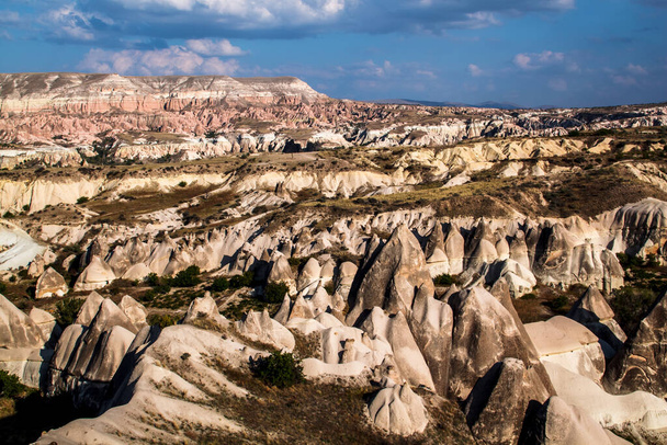 Stone pillars in Goreme national park. Goreme village, Anatolia, Turkey, Asia. - Фото, изображение