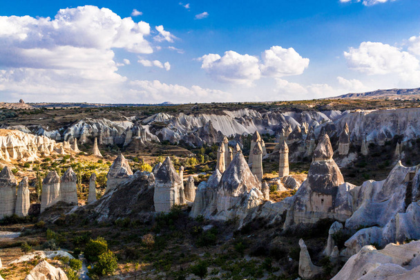 Stone pillars in the Love valley in in Goreme national park. Goreme village, Anatolia, Turkey, Asia. - Fotografie, Obrázek