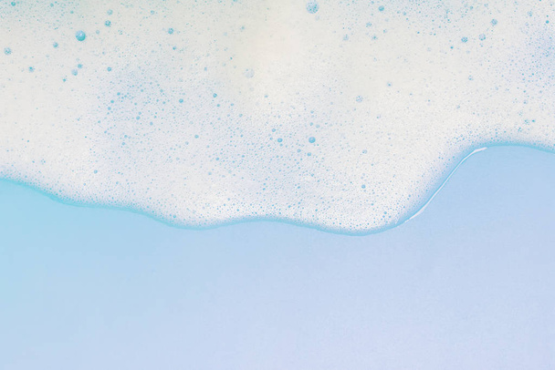 White foam on pastel blue background - Fotografie, Obrázek