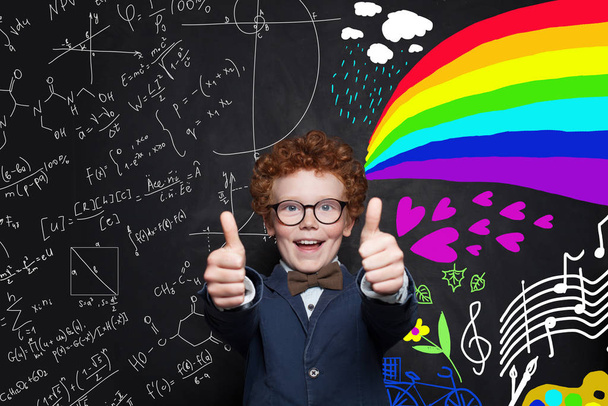 Happy successful child having fun against science formulas  - Photo, Image